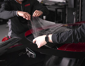 Paint Protection Film being installed on Red Ford GT