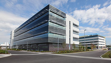 Contemporary office buildings with reflective glass facades.