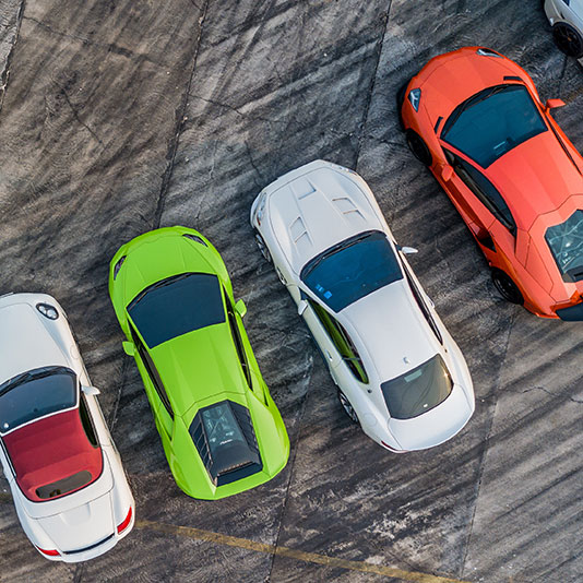 Overhead view of colorful sports cars parked side by side.