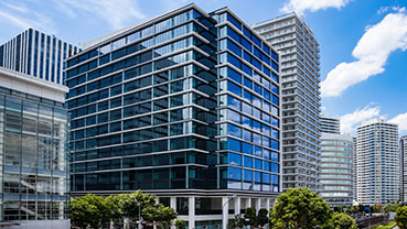 Tall modern building with blue‑tinted glass windows.