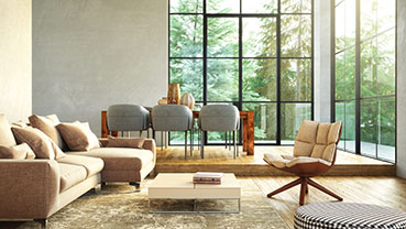 Bright living and dining area with large windows overlooking greenery.