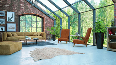 Sunroom-style living space with brick walls, large windows, and modern seating.