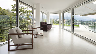 Bright room with floor-to-ceiling windows and modern seating.