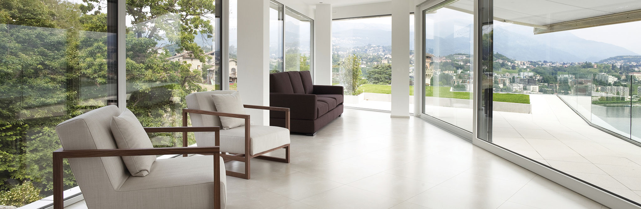 Bright room with floor-to-ceiling windows and modern seating. 