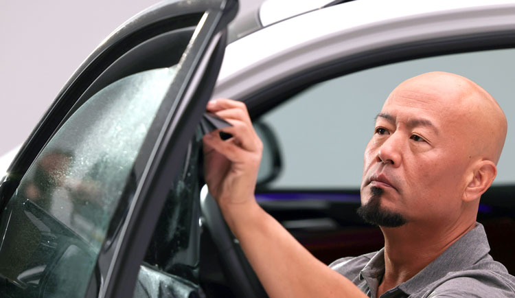 LLumar dealer installing window film on car 